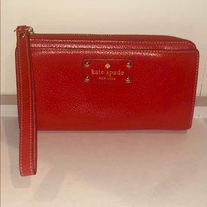 Kate Spade orange/red wristlet wallet.